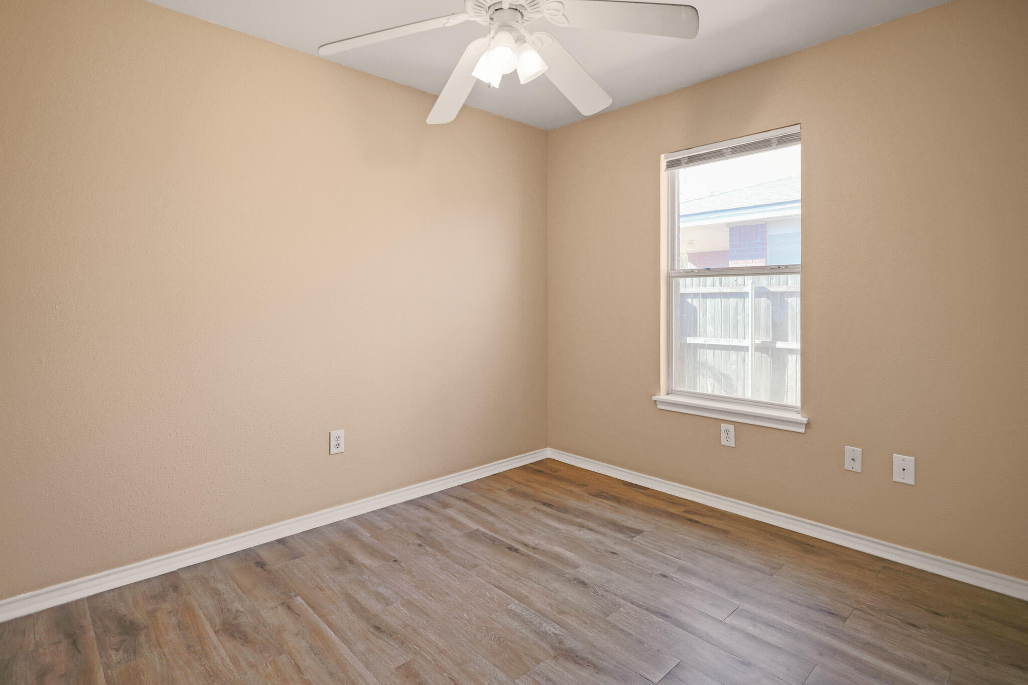5903 10th Street, Unit 2 Lubbock, TX 79416 - Photo 29 of 47 an empty room with wooden floor and windows