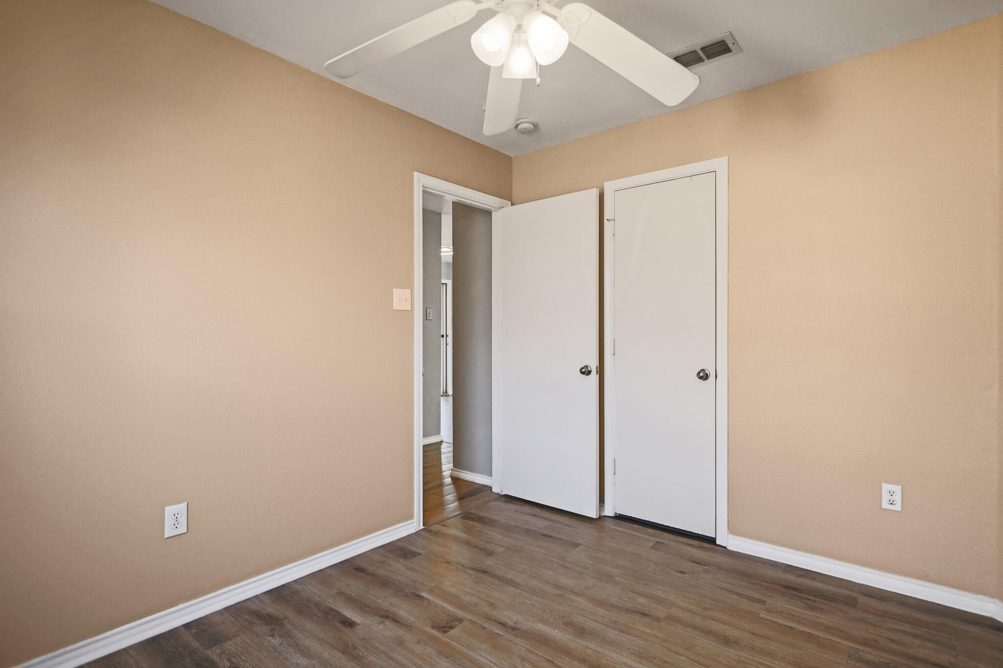 5903 10th Street, Unit 2 Lubbock, TX 79416 - Photo 30 of 47 a view of an empty room with wooden floor