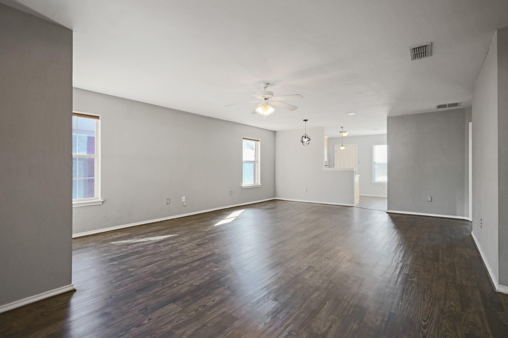 5903 10th Street, Unit 2 Lubbock, TX 79416 - Photo 3 of 47 an empty room with wooden floor and windows