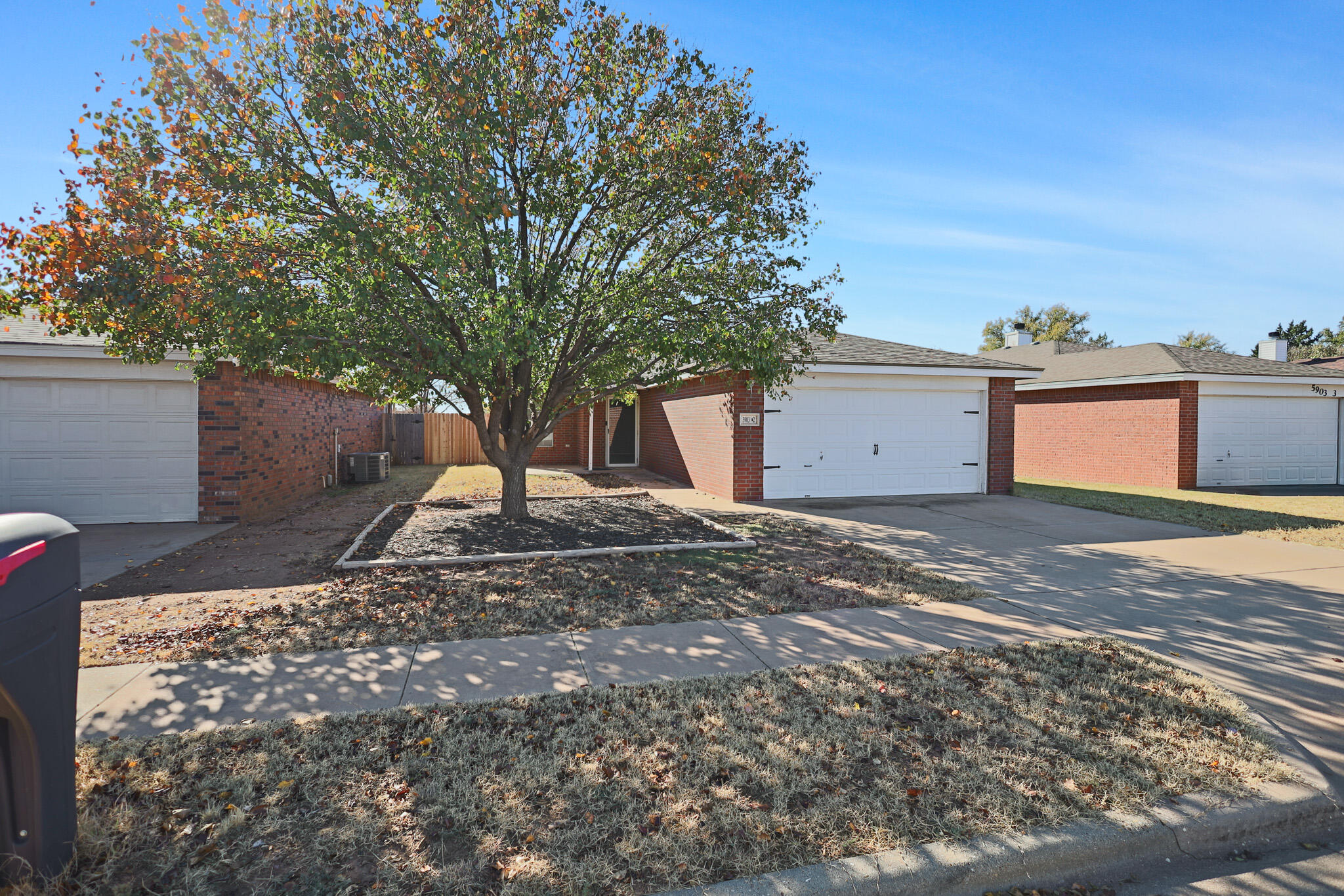 5903 10th Street, Unit 2 Lubbock, TX 79416 - Photo 43 of 47 a view of a backyard with large trees