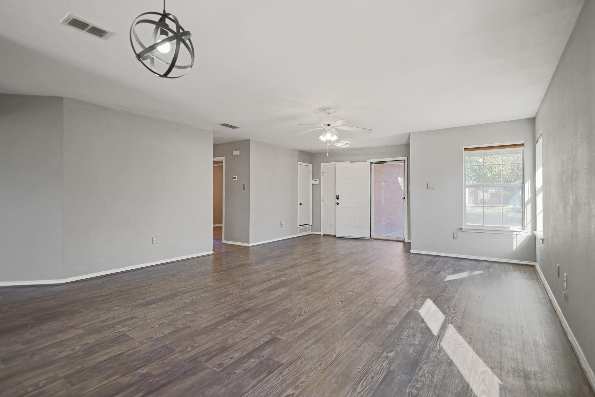 5903 10th Street, Unit 2 Lubbock, TX 79416 - Photo 7 of 47 a view of a room with wooden floor and window