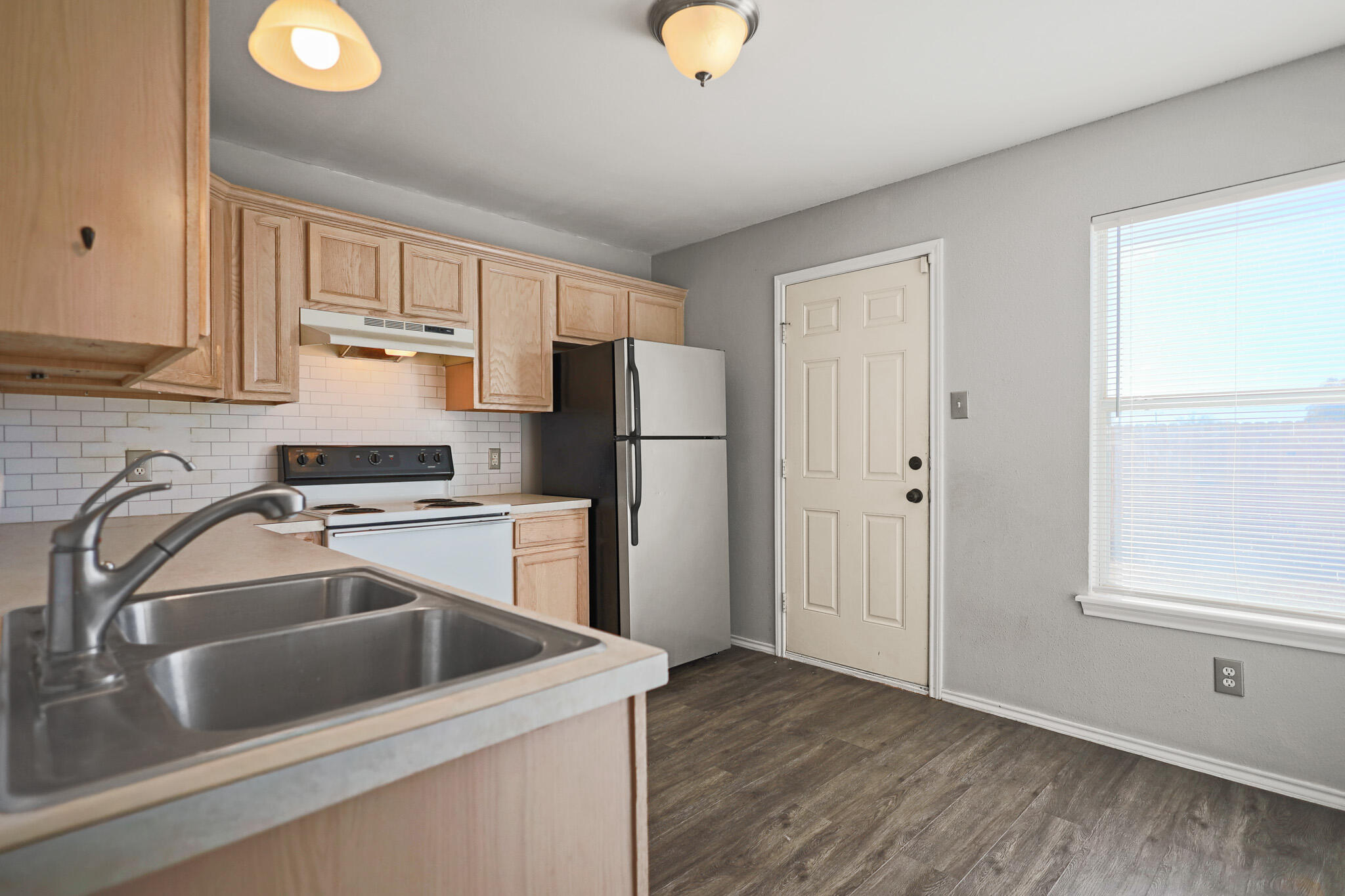 5903 10th Street, Unit 2 Lubbock, TX 79416 - Photo 10 of 47 a kitchen with a refrigerator sink and cabinets