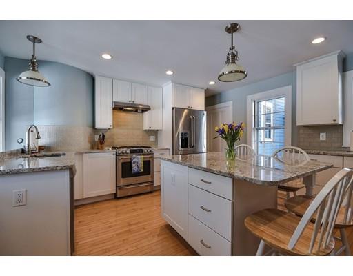 72 Main Street Framingham, MA 01702 - Photo 15 of 28 a kitchen with stainless steel appliances kitchen island granite countertop a stove refrigerator and cabinets