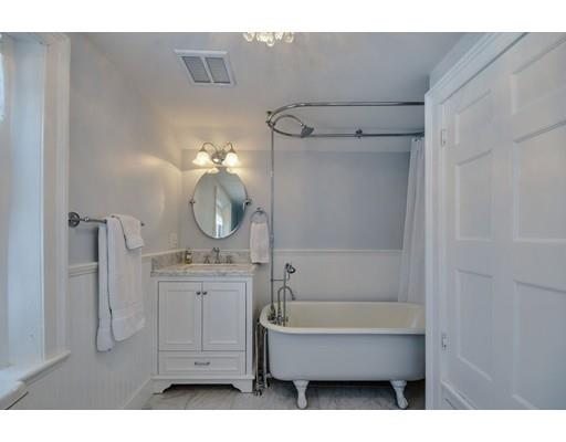 72 Main Street Framingham, MA 01702 - Photo 20 of 28 a bathroom with a tub sink and mirror