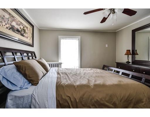 72 Main Street Framingham, MA 01702 - Photo 24 of 28 a bedroom with a bed and a painting on the wall