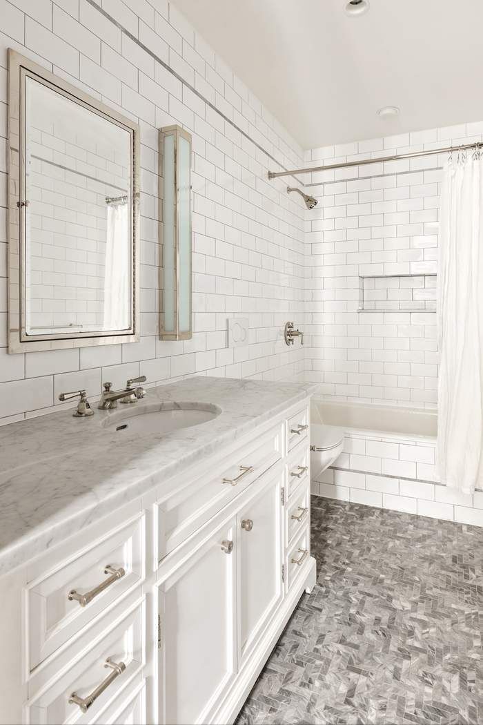 458 Broadway, Unit 6 Manhattan, NY 10013 - Photo 10 of 18 a bathroom with a sink a vanity and a bathtub