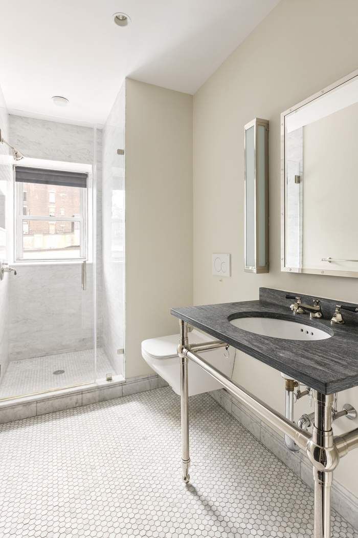 458 Broadway, Unit 6 Manhattan, NY 10013 - Photo 13 of 18 a bathroom with a sink and a mirror
