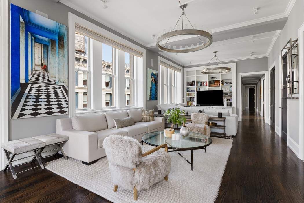 458 Broadway, Unit 6 Manhattan, NY 10013 - Photo 2 of 18 a living room with furniture and a flat screen tv
