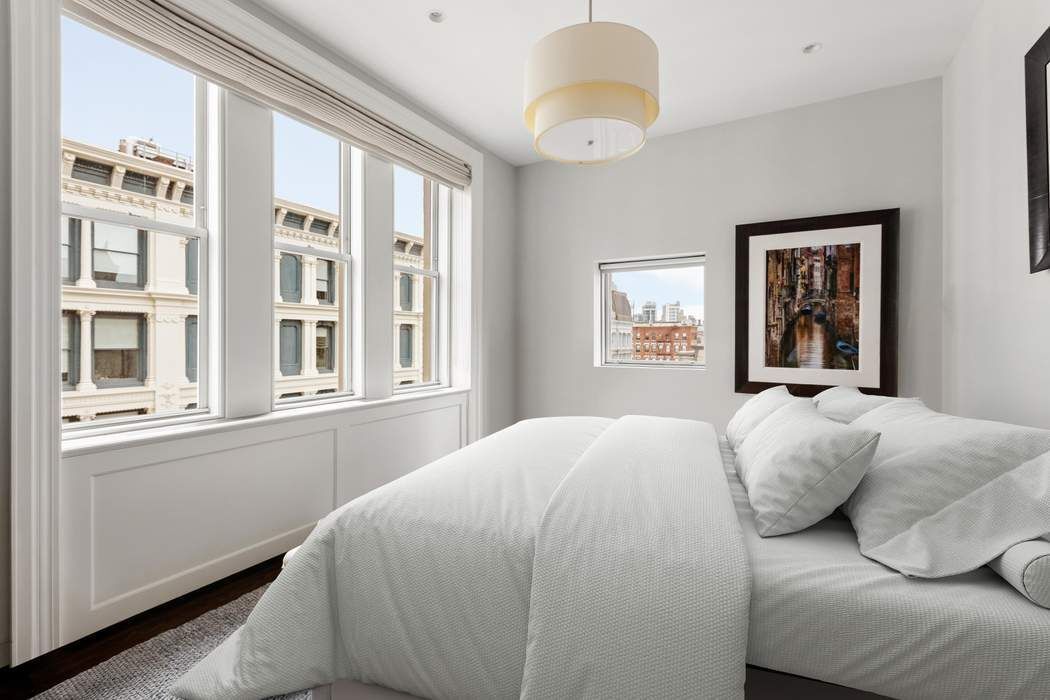 458 Broadway, Unit 6 Manhattan, NY 10013 - Photo 7 of 18 a bedroom with a bed and a large window