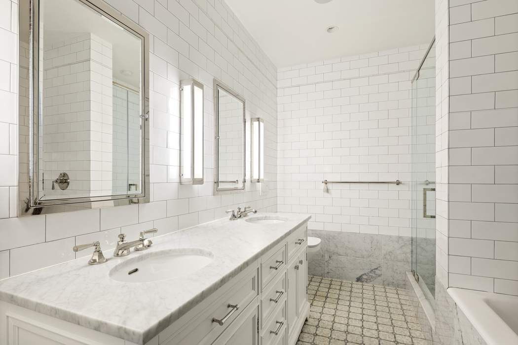 458 Broadway, Unit 6 Manhattan, NY 10013 - Photo 8 of 18 a bathroom with double vanity sink a mirror and a shower