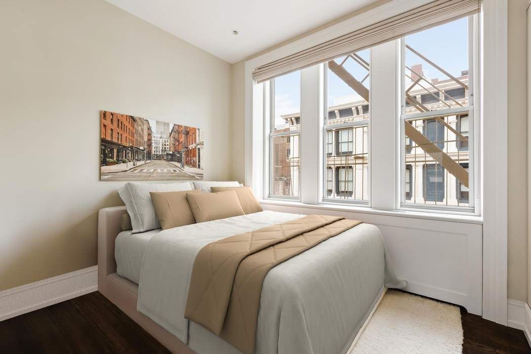 458 Broadway, Unit 6 Manhattan, NY 10013 - Photo 9 of 18 a bedroom with a large bed and a large window