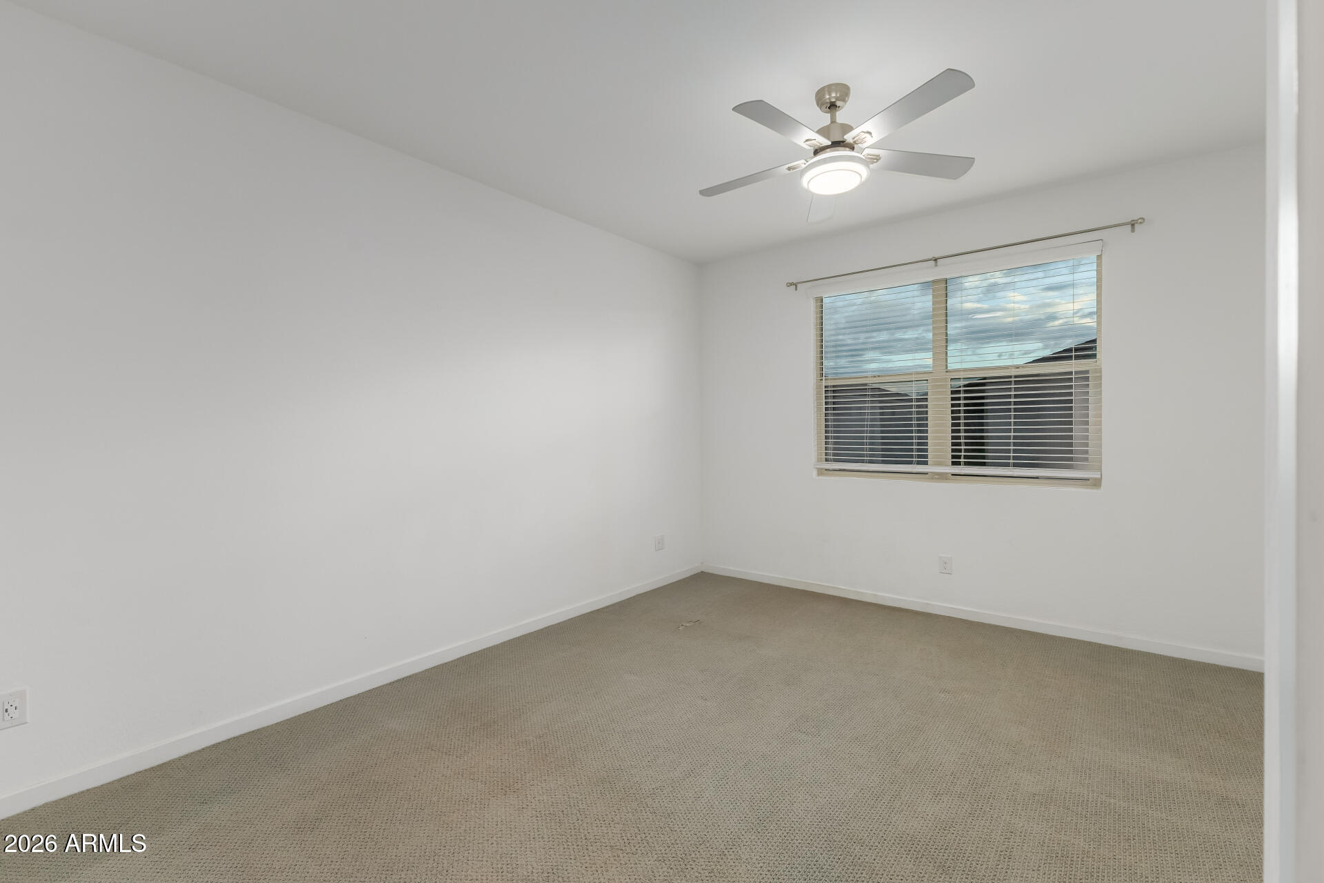 4337 East Italian Trotter Road San Tan Valley, AZ 85140 - Photo 18 of 35 an empty room with window and ceiling fan