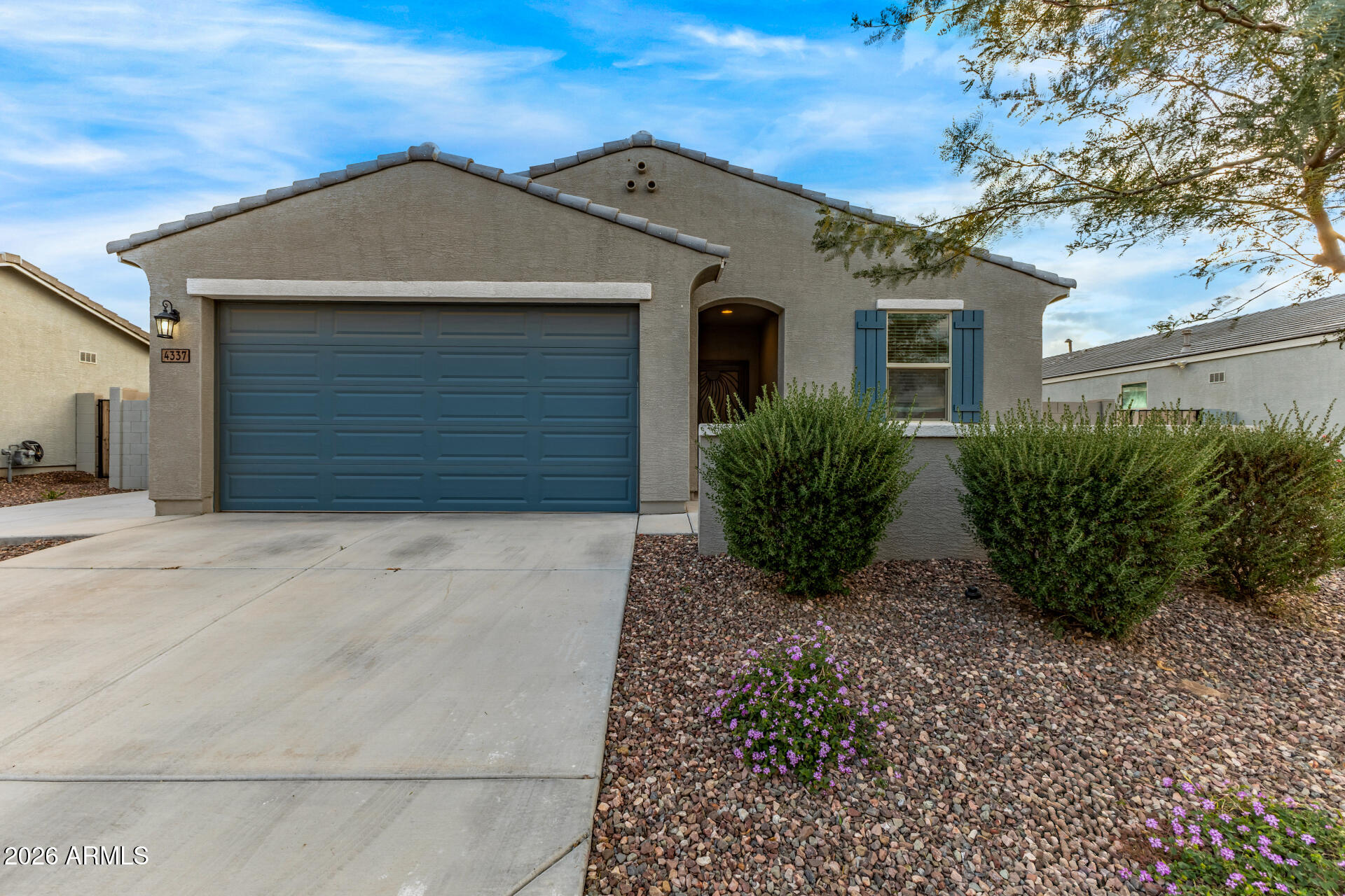 4337 East Italian Trotter Road San Tan Valley, AZ 85140 - Photo 2 of 35 a front view of a house with a yard