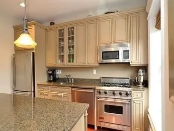 a kitchen with stainless steel appliances granite countertop a stove a microwave and a refrigerator