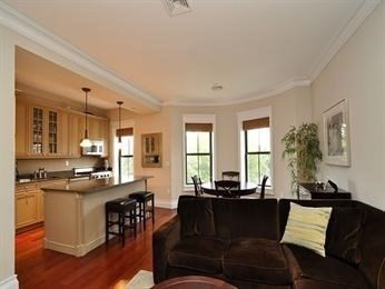 684 Tremont Street, Unit 5 Boston, MA 02118 - Photo 4 of 10 a living room with furniture a wooden floor and a large window
