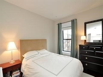 684 Tremont Street, Unit 5 Boston, MA 02118 - Photo 8 of 10 a bedroom with a bed and a window