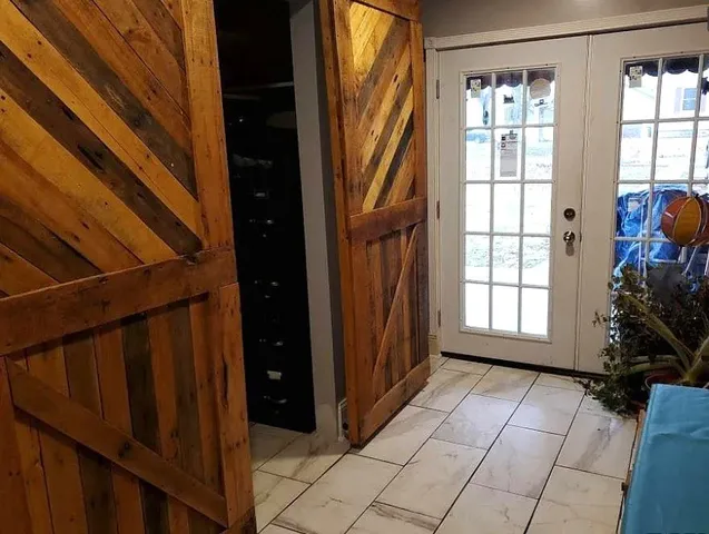 a view of entryway with a front door and wooden floor