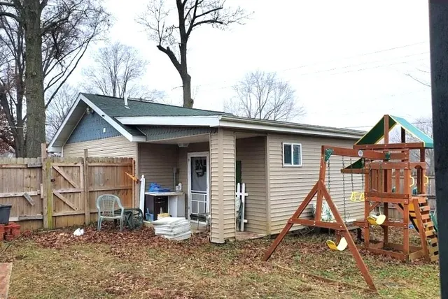 a view of a house with a yard and sitting area