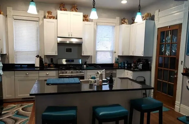 a kitchen with a table chairs stove and cabinets