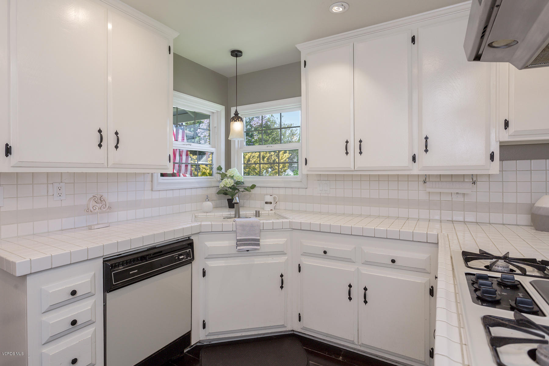 60 Marvin Court Simi Valley, CA 93065 - Photo 7 of 24 a kitchen with white cabinets and white appliances