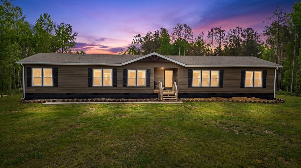 195 Roddy Springs Road Coalmont, TN 37313 - Photo 1 of 44 a front view of a house with a yard table and chairs