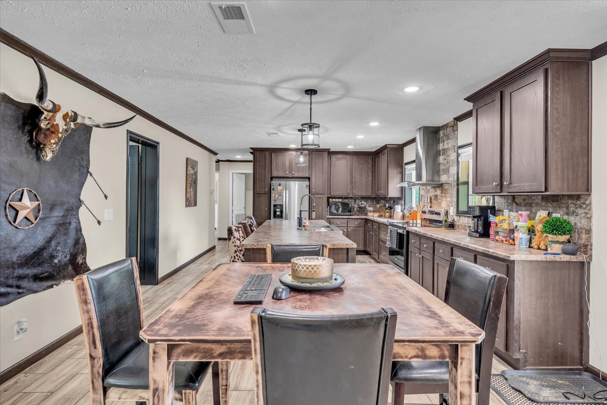 195 Roddy Springs Road Coalmont, TN 37313 - Photo 11 of 44 a kitchen with a table chairs refrigerator and microwave