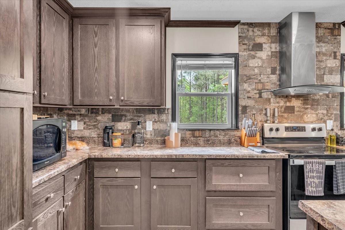 195 Roddy Springs Road Coalmont, TN 37313 - Photo 12 of 44 a kitchen with stainless steel appliances granite countertop a sink and a stove next to a window