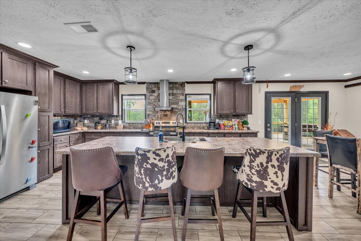 195 Roddy Springs Road Coalmont, TN 37313 - Photo 31 of 44 a kitchen with a dining table chairs stainless steel appliances and cabinets