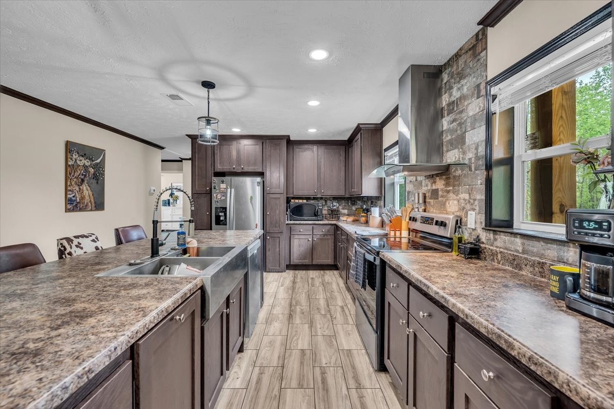 195 Roddy Springs Road Coalmont, TN 37313 - Photo 8 of 44 a kitchen with granite countertop kitchen island stainless steel appliances a sink stove and refrigerator