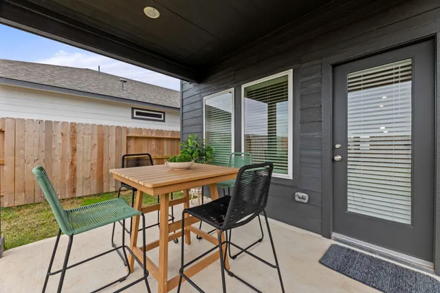 a table and chairs in front of a window