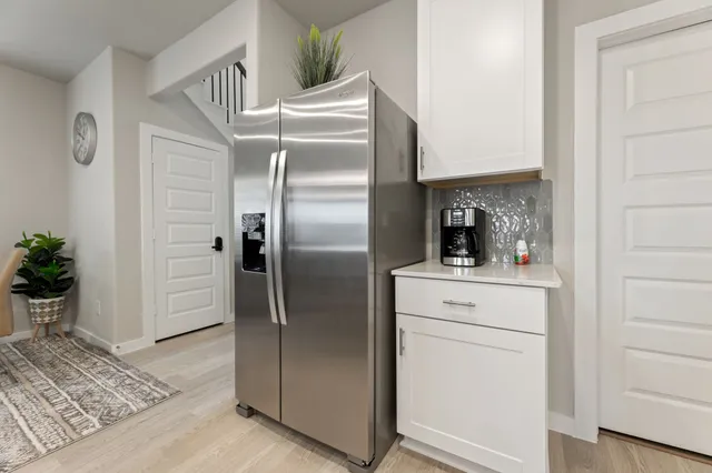 a kitchen with a refrigerator and cabinets