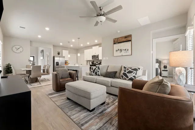 a living room with furniture and a chandelier