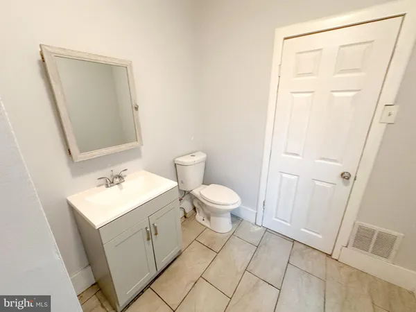 a bathroom with a sink toilet and mirror