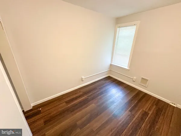 an empty room with wooden floor