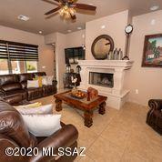 407 Camino Agua Fria Rio Rico, AZ 85648 - Photo 12 of 41 a living room with furniture a fireplace and a large window