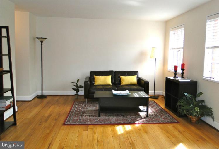 8722 Manchester Road, Unit 7 Silver Spring, MD 20901 - Photo 2 of 16 a living room with furniture and a fireplace