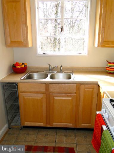 8722 Manchester Road, Unit 7 Silver Spring, MD 20901 - Photo 11 of 16 a kitchen with a sink cabinets and window