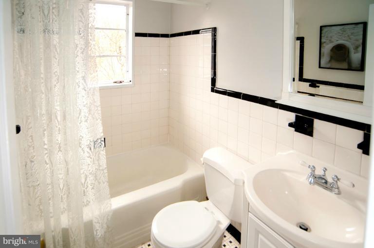 8722 Manchester Road, Unit 7 Silver Spring, MD 20901 - Photo 14 of 16 a bathroom with a sink toilet and shower