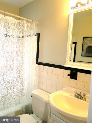 8722 Manchester Road, Unit 7 Silver Spring, MD 20901 - Photo 15 of 16 a bathroom with a sink and a mirror