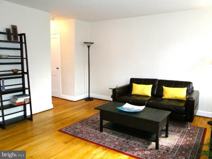 8722 Manchester Road, Unit 7 Silver Spring, MD 20901 - Photo 3 of 16 a living room with furniture and a wooden floor