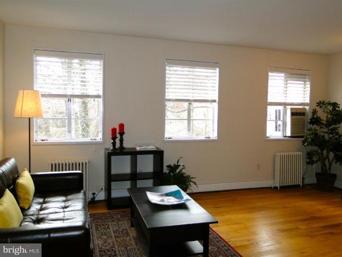 8722 Manchester Road, Unit 7 Silver Spring, MD 20901 - Photo 4 of 16 a living room with furniture and a window