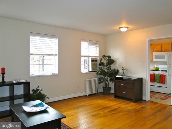 8722 Manchester Road, Unit 7 Silver Spring, MD 20901 - Photo 5 of 16 a living room with furniture and wooden floor