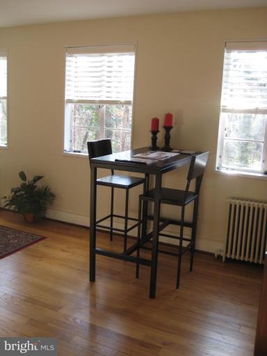 8722 Manchester Road, Unit 7 Silver Spring, MD 20901 - Photo 7 of 16 a workspace with furniture window and wooden floor