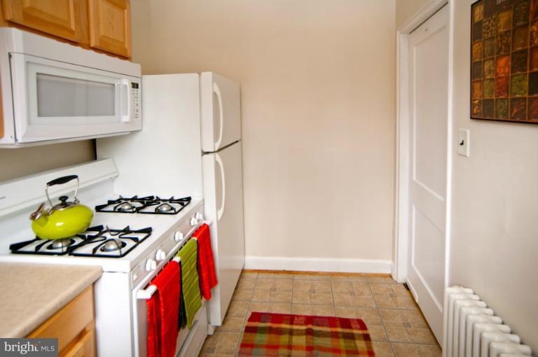 8722 Manchester Road, Unit 7 Silver Spring, MD 20901 - Photo 9 of 16 a kitchen with stainless steel appliances granite countertop a stove and a refrigerator