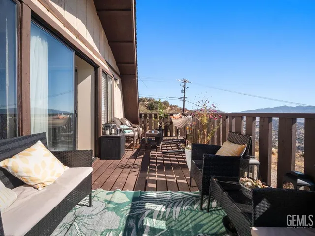 a view of a white house with a yard in front of it