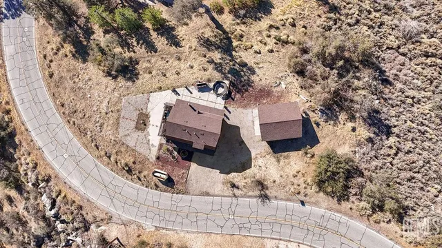 an aerial view of a house with deck and wooden fence