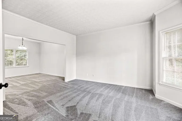 a view of a room with a ceiling fan and a window