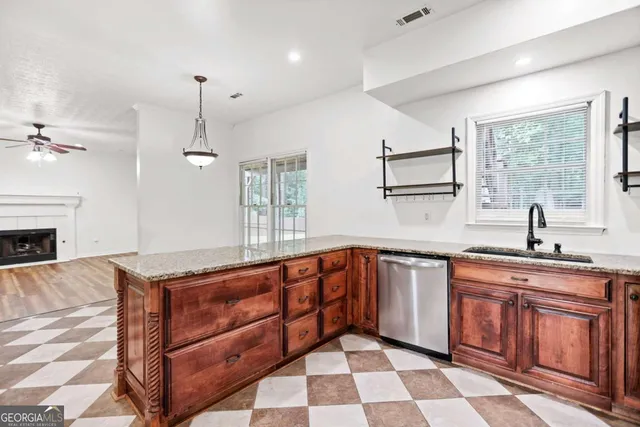 a kitchen with stainless steel appliances granite countertop a refrigerator and a sink