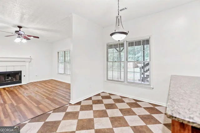 a view of a livingroom with a fireplace and window