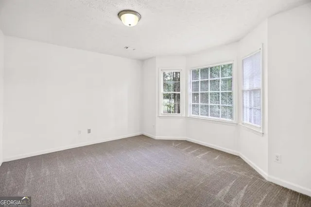 a view of empty room with ceiling fan